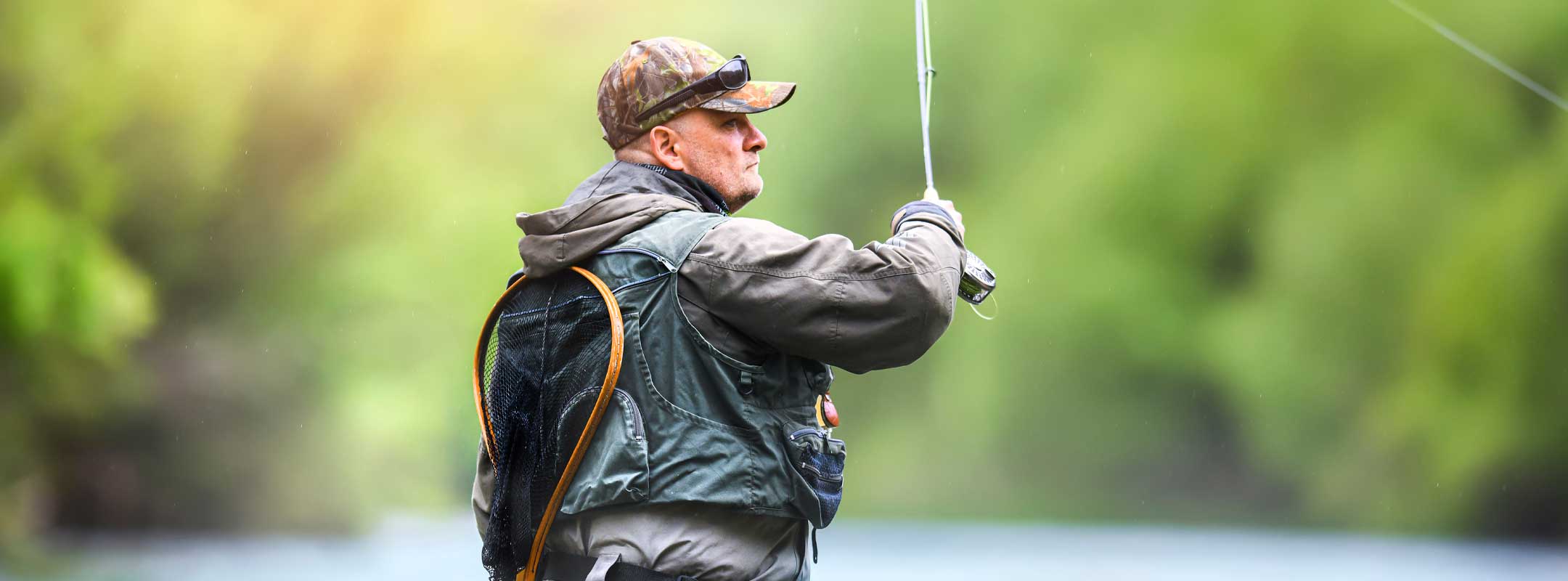 Man fly fishing on a river with nymph flies