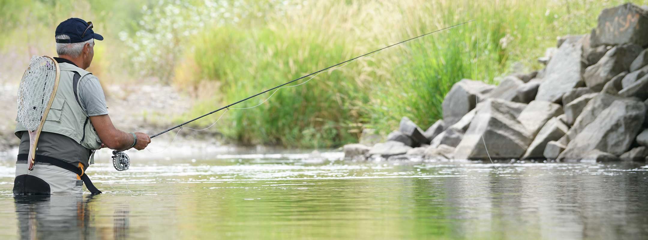 man fly fishing with dry flies