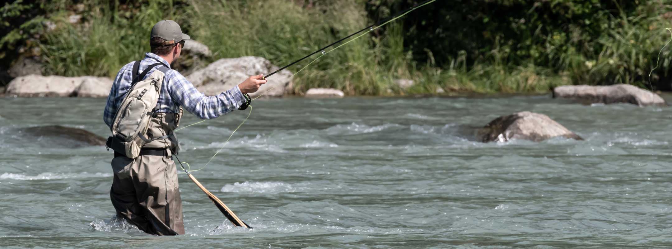 fly fishing man using copper john nymphs on a river