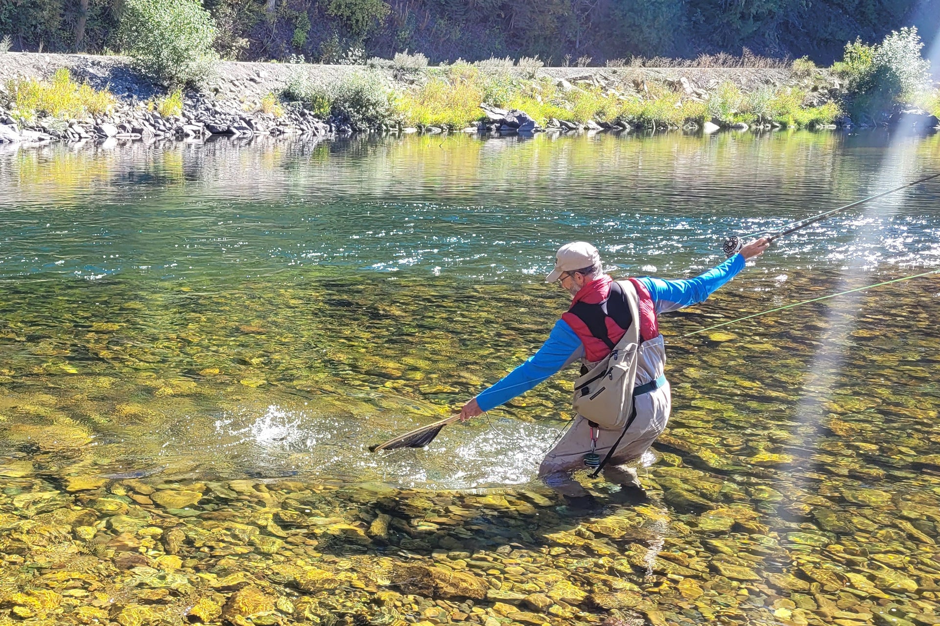 Fisherman using san juan power worm wet flies in a scenic river for trout fishing