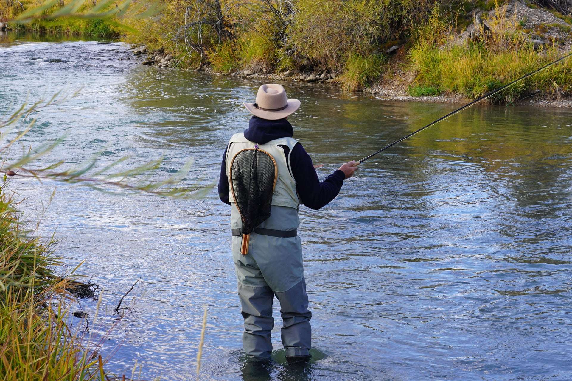 Angler fly fishing in a river with Long Tail Skwala Stone Fly Dry Trout Flies - Adult Squalla Stonefly Dry Fly - 6 Flies Hook Size 10